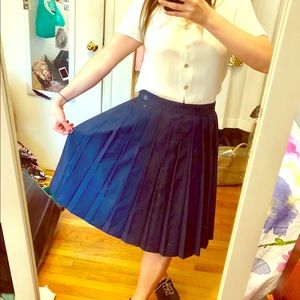 Mid length pleated baby skirt.